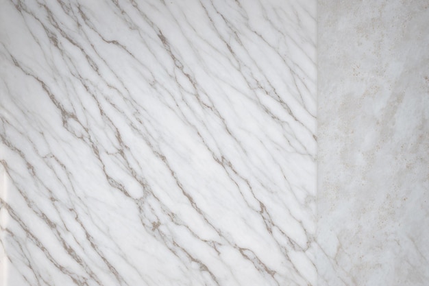 A close up of a white marble tile with a square cut out.