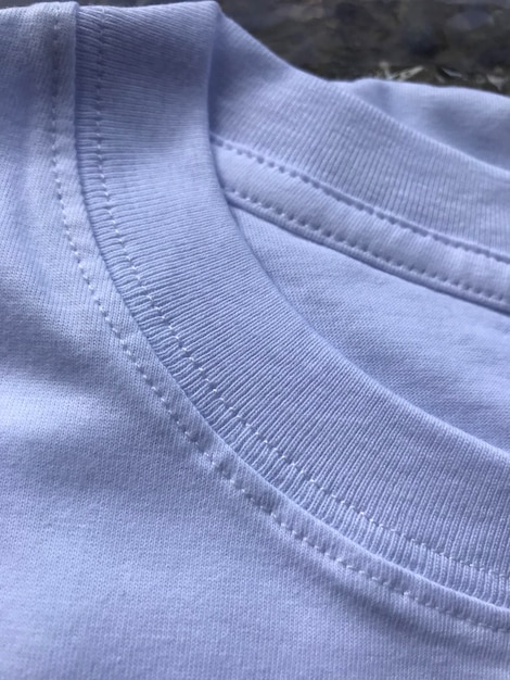 A close up of a white shirt with a stitched edge.