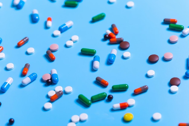 Close up of white tablets and colorful capsules