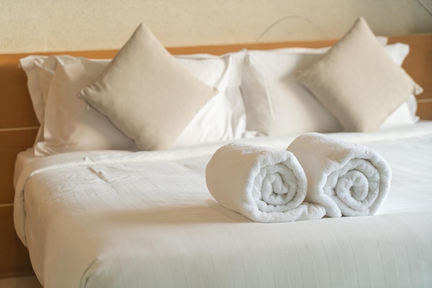 close-up white towel on bed in bedroom