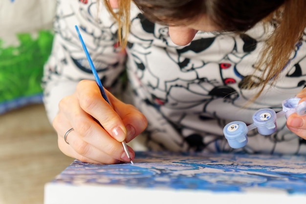 Close Up of woman Artist Hand Holding Paint Brush and Drawing Oil Painting Selective focus