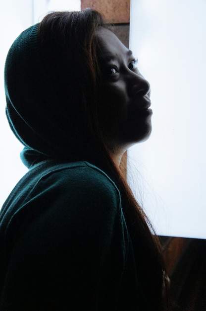 Photo close-up of woman by window at home