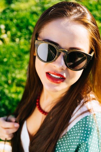 Close up woman face in sunglasses,wooden glasses,whitening