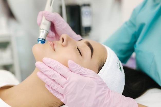 Close-up of woman getting facial hydro microdermabrasion peeling treatment. Female at cosmetic