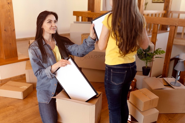 Close up woman and girl unpacking