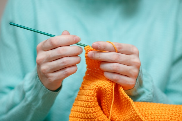 Photo close up of woman hand crochet woolen sweater