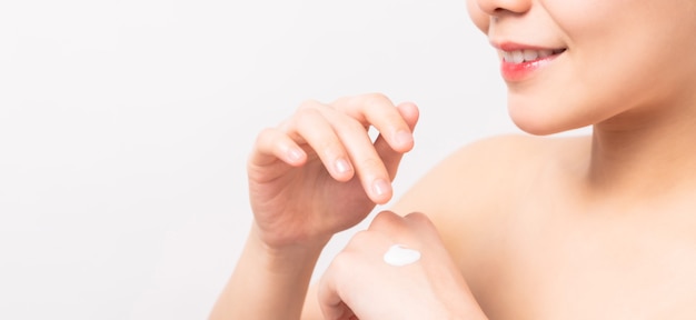 Close up of woman hand holding and applying moisturiser, Body lotion, isolated on white background.