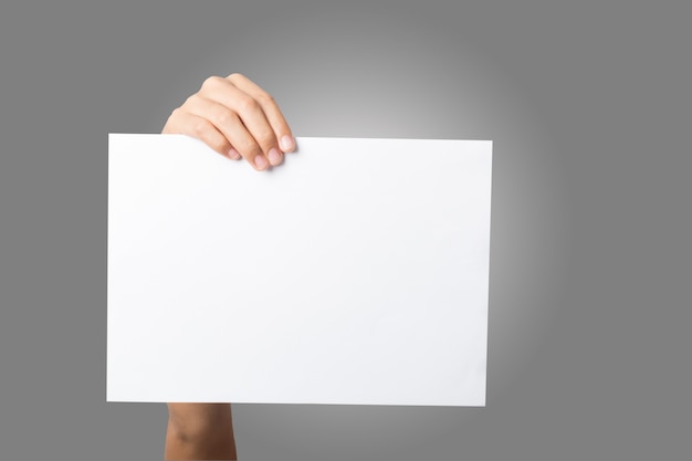 Close Up of woman hand holding blank paper isolated on white background