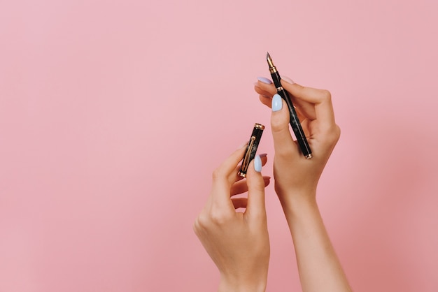 Close up of a woman hand holding a pen