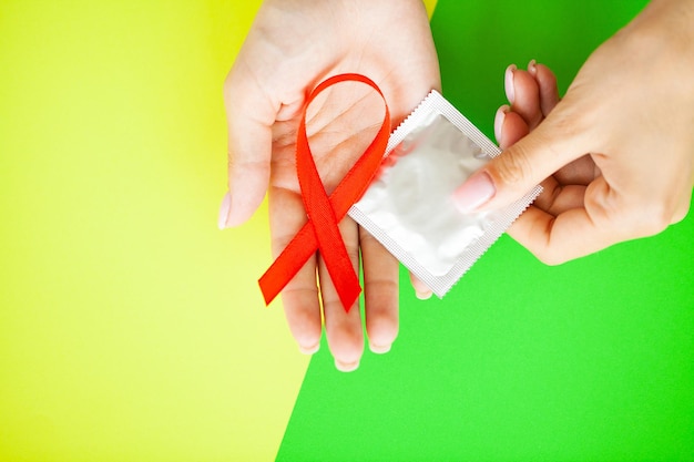 Photo close up woman hand holding red ribbon hiv world aids day awareness ribbon