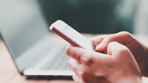 Close up woman hand holding smart mobile phone and using fingers scrolling typing on screen display