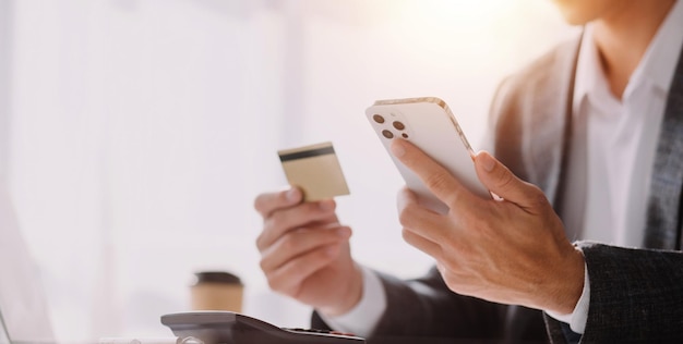 Close up of woman hand using credit card and laptop for payment and online shopping Online shopping payments digital banking Ecommerce concept