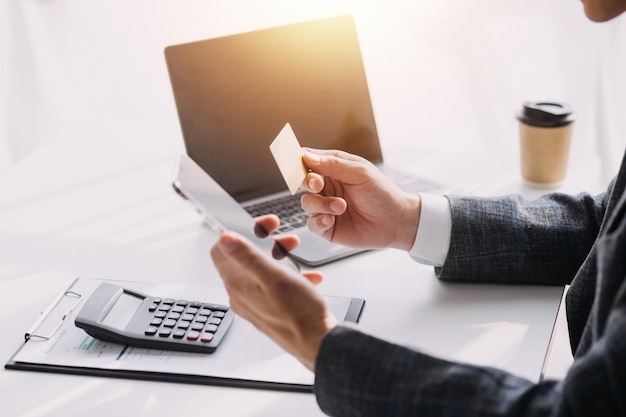 Close up of woman hand using credit card and laptop for payment and online shopping Online shopping payments digital banking Ecommerce concept