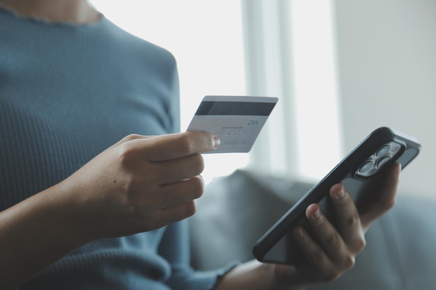 Close up of woman hand using credit card and laptop for payment and online shopping Online shopping payments digital banking Ecommerce concept