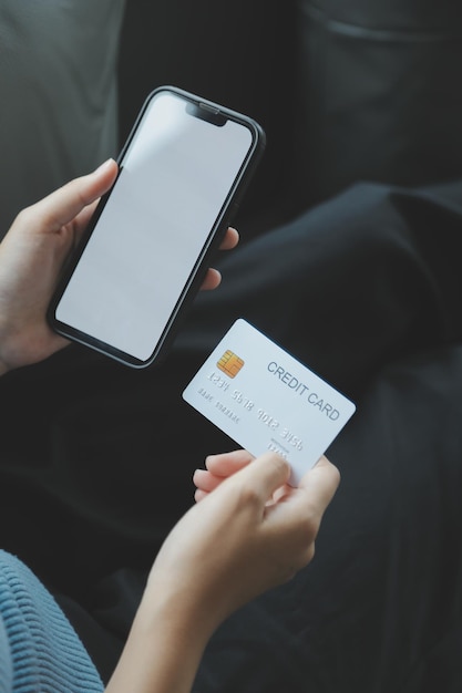 Close up of woman hand using credit card and laptop for payment and online shopping Online shopping payments digital banking Ecommerce concept