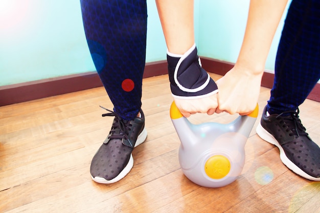 Close up woman hands holding kettlebell