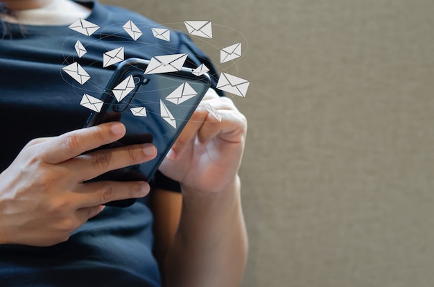 Close-up woman holding a cell phone an icon email message. Marketing business sending information to customers or hacking online transactions. Business concept technology.