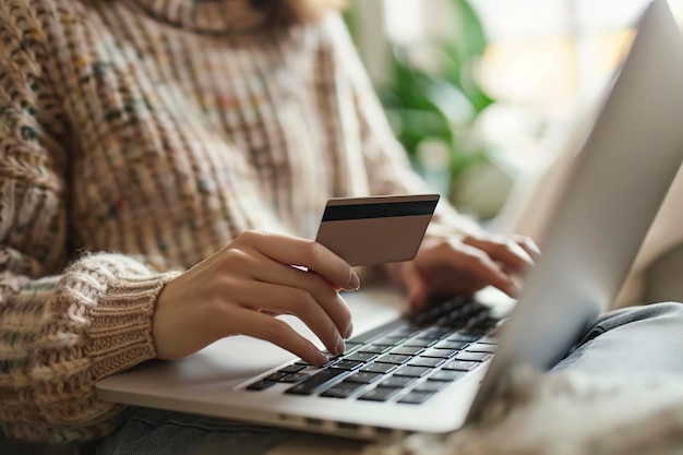 A Close up of a woman holding credit card and typing