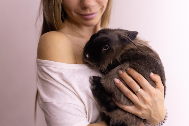 Close up woman holding cute fluffy rabbit animal and pet concept