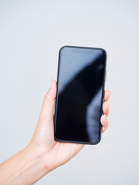 Close-up of woman holding smartphone with a blank screen