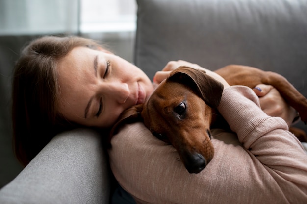 Close up on woman hugging her pet dog