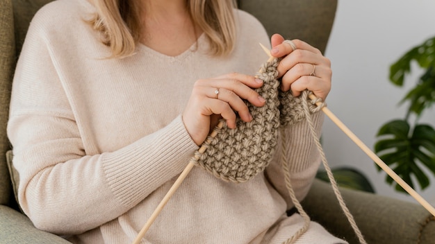 Close-up woman knitting