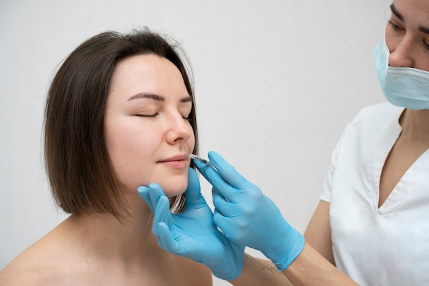 Close up on woman during lip filler procedure