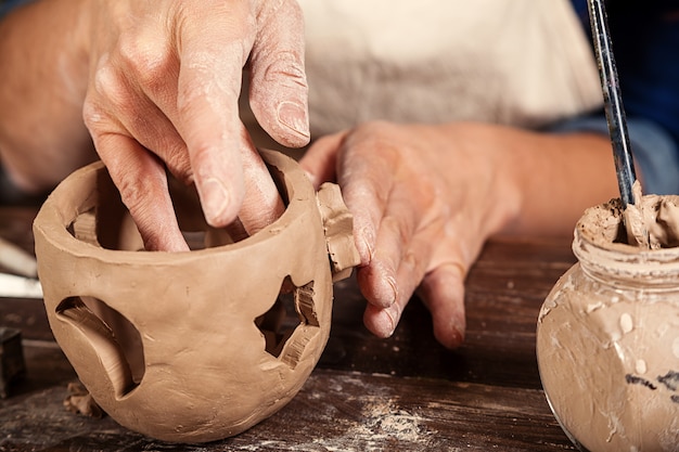 Close up of woman making pottery