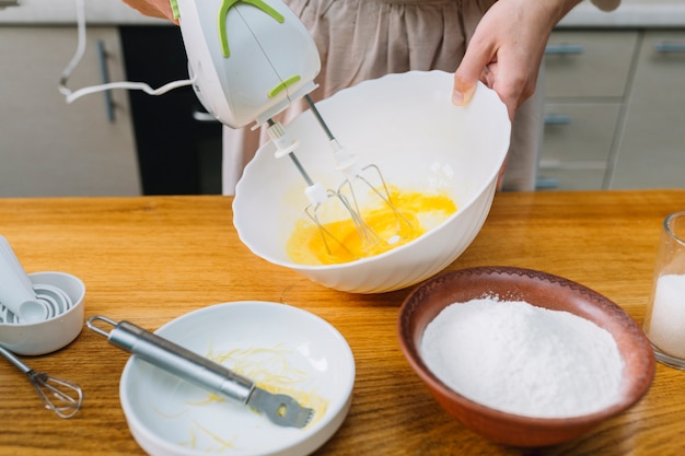 Close-up of a woman mixing egg in bowl