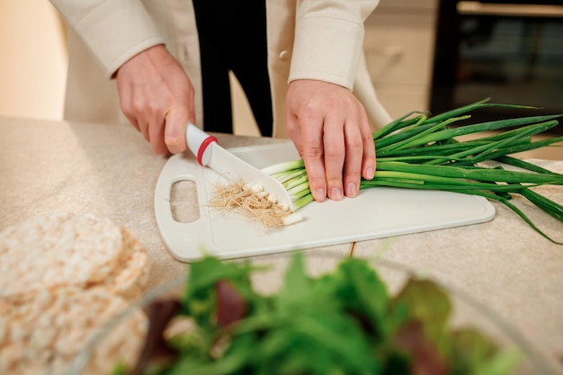 Close up of woman preparing vegetable vegan salad in the kitchen Healthy food and diet concept lifestyle Cook at home