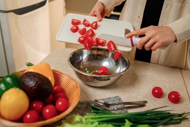 Close up of woman preparing vegetable vegan salad in the kitchen Healthy food and diet concept lifestyle Cook at home