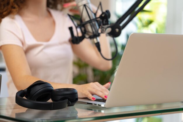 Close up of a woman recording a podcast in a studio