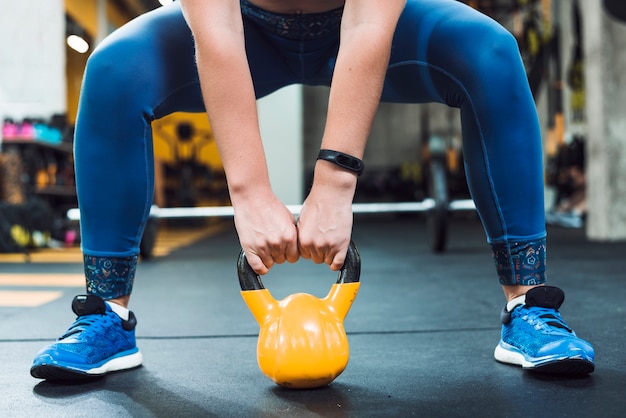 Close-up of a woman's hand doing exercise with kettle ball