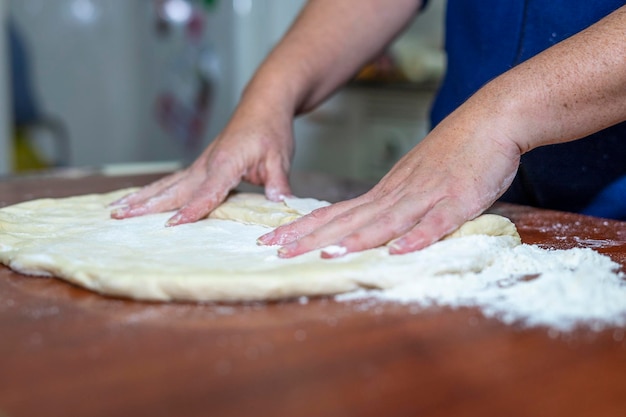 Close up of woman's  hands making dough for homemade bread