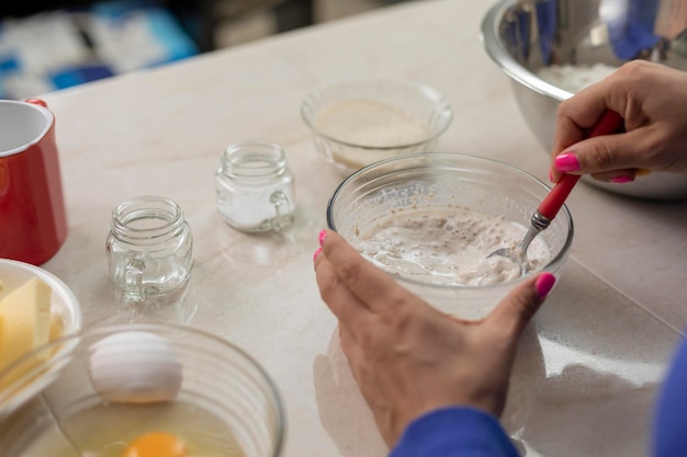 Close up of woman's hands mixing yeast to make bread