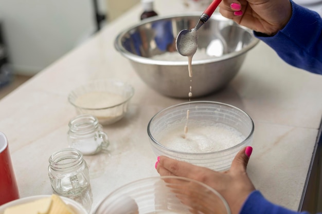 Close up of woman's hands mixing yeast to make bread