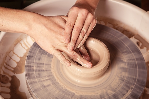 Close up of a woman sculpting clay