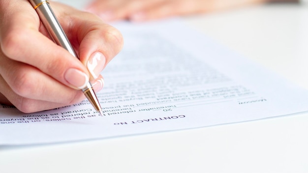 Close up of a woman signing contract