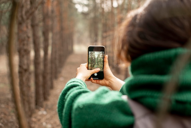 Close-up woman taking photos with mobile