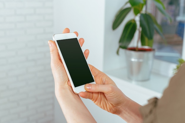 Close up of woman texting on smartphone