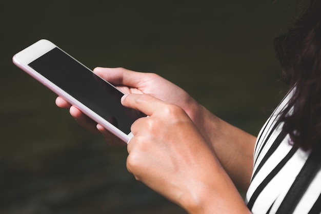 Close up of a woman using mobile smart phone