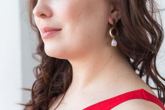 Close-up of woman wearing a gold necklace. Jewelry, bijouterie and accessories.