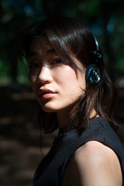 Close up woman wearing headphones outdoors