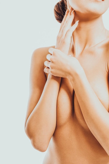 Close-up of woman with hand on white background