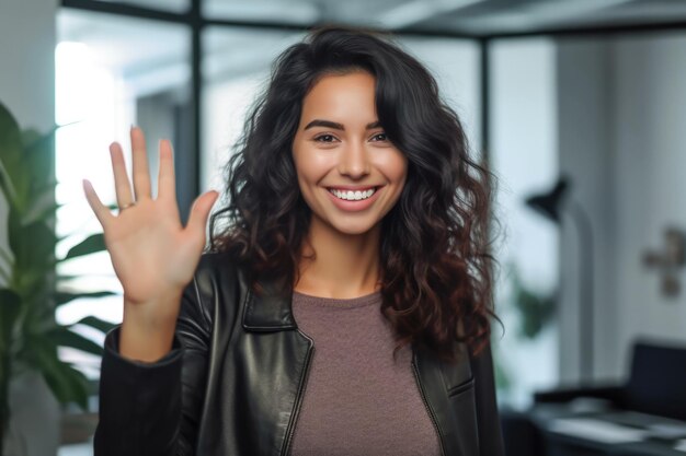 Close up of a woman at work smiling at her workplace and giving a high five to the camera