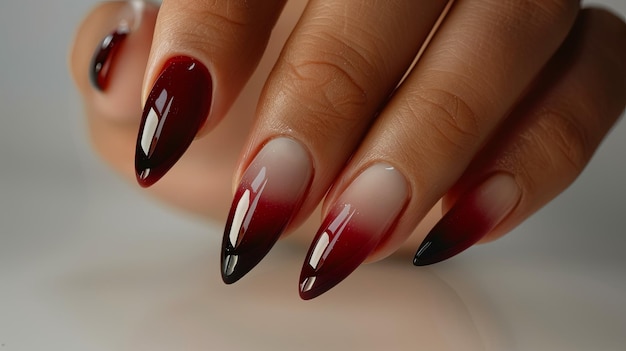 Close Up of a Womans Hand With Red and Black Ombre Nail Polish