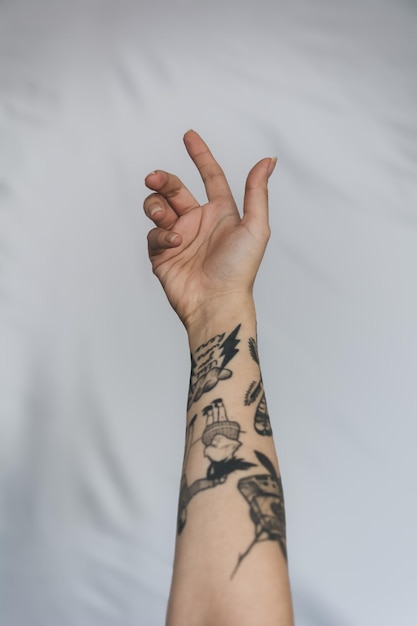 Photo close-up of womans hand with tattoo against white background