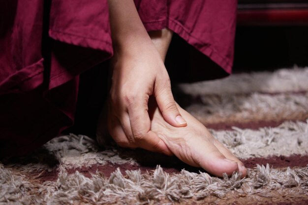 Close up on women feet and hand massage on injury spot