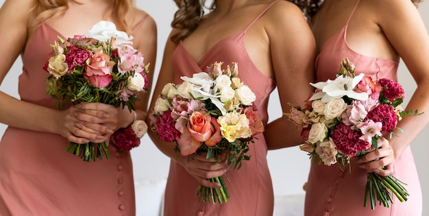 Close up women holding flowers bouquets