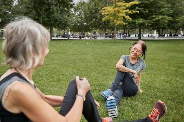 Close up women sitting on grass